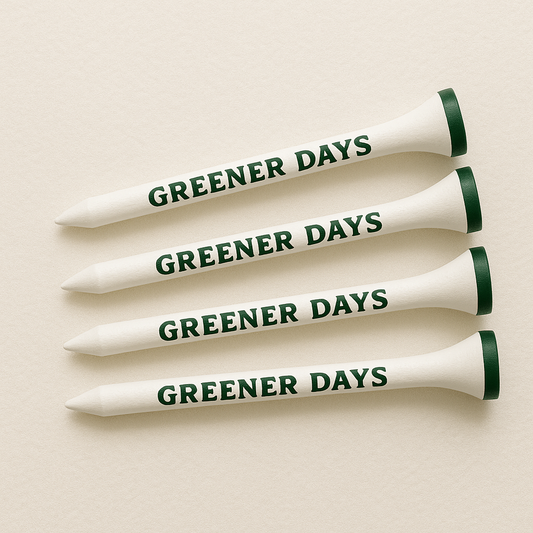 Set of four white wooden golf tees with “Greener Days” printed in green, clean and classic golf accessory for tee shots.